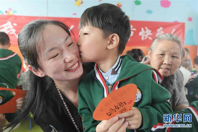5月10日，在湖北省襄陽市一家幼兒園舉辦的母親節(jié)主題活動中,，一名小朋友將自己制作的賀卡獻(xiàn)給媽媽,。 新華社發(fā)（安富斌 攝）